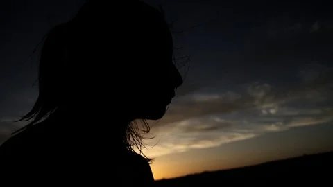 Silhouette of person as sun sets Stock Footage 99326823