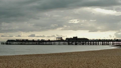 Silhouette pier and empty beach around sunset in Hastings slow motion 4K Stock Footage 289483373