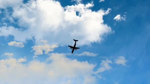 Silhouette plane on flight cloudy and bright day.  Stock Footage 98135164