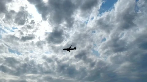 Silhouette of a plane flying before landing on the background of evening sky. Stock Footage 282378347