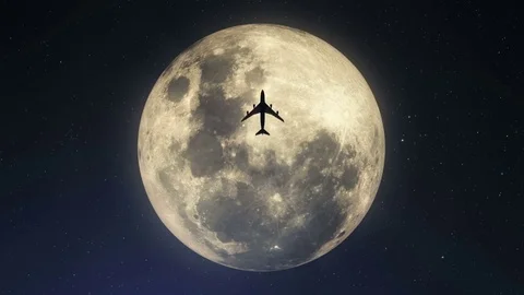 Silhouette of plane passing over super moon Stock Footage 80170907