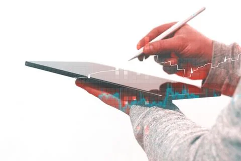 Silhouette of professional using tablet device with stylus combined with re.. Foto stock