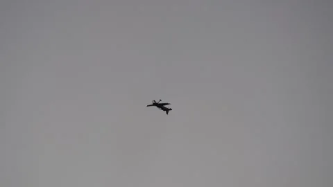Silhouette of a propeller plane performing an aerobatic loop with smoke trail Stock Footage 340938780