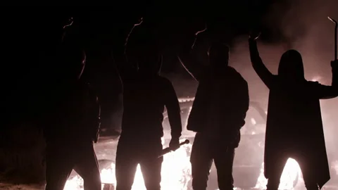 Silhouette of protesting guys with baseball bats and crowbar, raising their Stock Footage 139918565