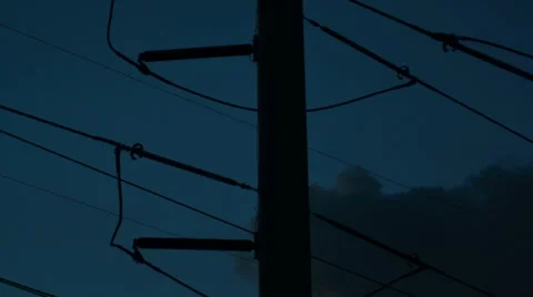 Silhouette of public electricity system with clouds moving behind long 스톡 동영상 39354408