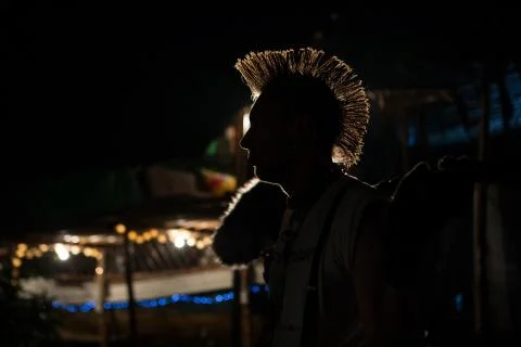 Silhouette of a punk with a Mohawk in the dark in the contra light Stock Photos