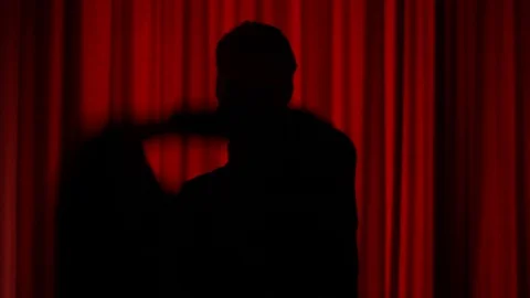 Silhouette puts on coat Stock Footage 87201476