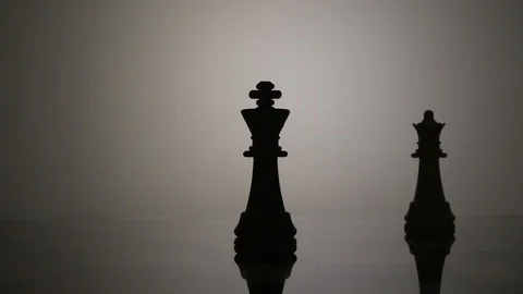 Silhouette of a queen taking a king in chess Stock Footage 92525462