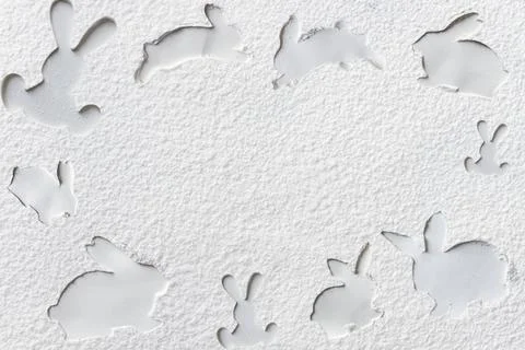 Silhouette of the rabbit spread a layer of flour on a dark background. Abstra Stock Photos