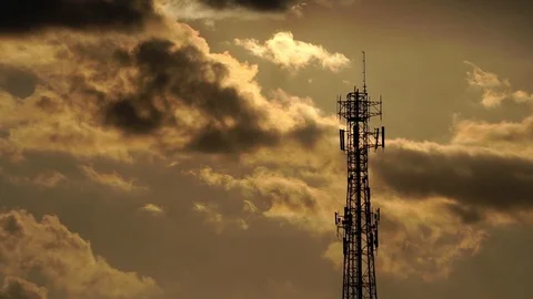 Silhouette radio antenna to communicate with clouds and cold light of sunset Stock Footage 112882425