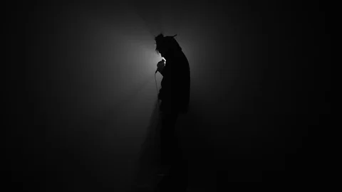 Silhouette of rapper performing with microphone Stock Footage 104060447