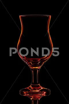 Silhouette of red cocktail glass with clipping path on black background Stock Photos