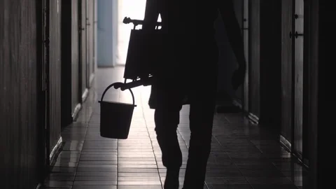 Silhouette of Renovation Worker Walking with Tools along Hallway Stock Footage 100798036