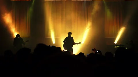 Silhouette of a rock concert: musicians, guitarist, stage, audience Stock Footage