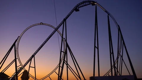 Silhouette of roller coaster against sunset sky Stock Footage 99446527
