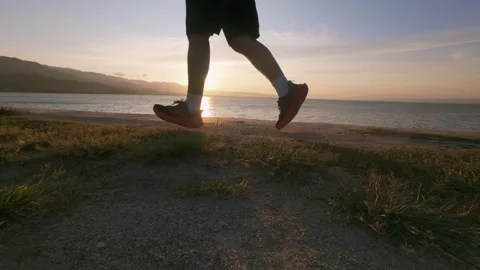 Silhouette of Runner at Sunset by the Water. Slow motion Stock Footage 303762948