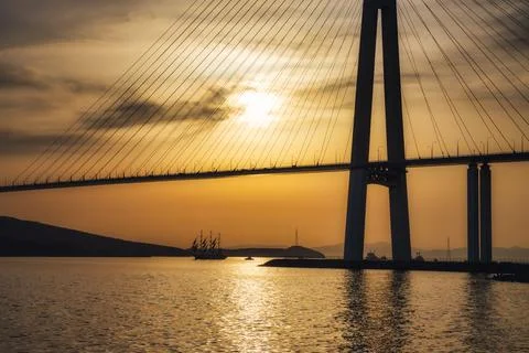 Silhouette of a sailboat under the cable-stayed bridge in Vladivostok, Russia Stock Photos