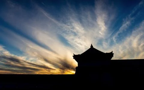 Silhouette scene of old building with dramatic sky at sunset Stock Photos