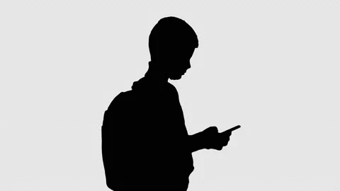 Silhouette Schoolboy with a backpack using mobile phone., Alpha Channel Stock Footage 155143678