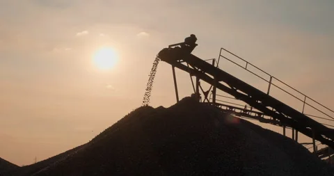 Silhouette of screening and washing in open-pit mining. Sorted rocks move on Stock Footage 290115116