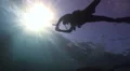 Silhouette of Scuba diver with sun beams HD Footage