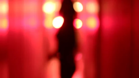 Silhouette of a sexy woman dancing in a blurry, red corridor Stock Footage 59553214