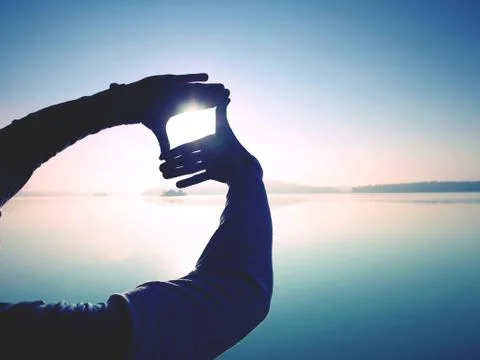 Silhouette of shadow shape being made by hands with sunlight Stock Photos