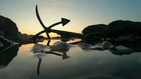 Silhouette of a ship anchor on the beach Stock Footage 133023394
