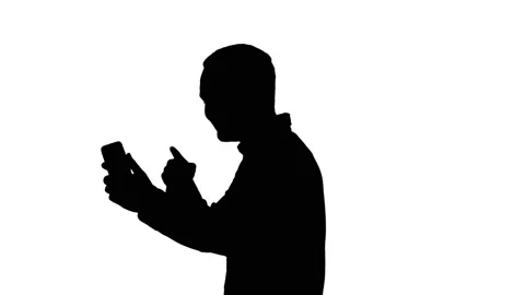 Silhouette Side view of young smart casual business man recording blog, vlog Stock Footage 100343762