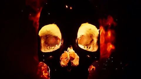 A Silhouette of skull on fire pushing back in front of black background Stock Footage 155225324