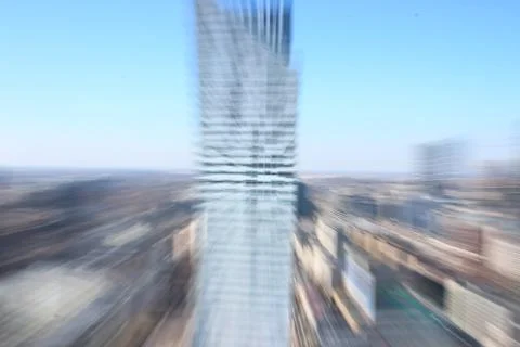 The silhouette of a skyscraper, the blur of the object, the look of a man wit Stock Photos