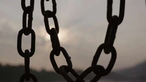 Silhouette slow motion chain with clouds behind Stock Footage 112516915