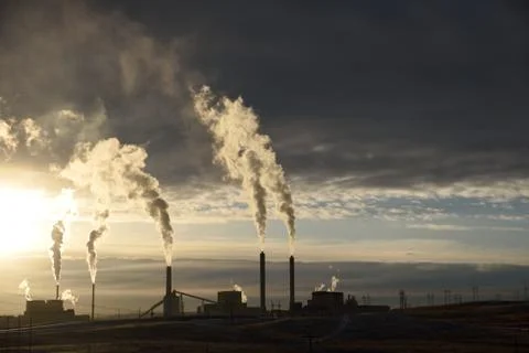 Silhouette of smoke stack emissions Stock Photos