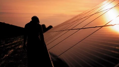 Silhouette of a Solar Panel Worker at Sunset Stock Footage 276290554