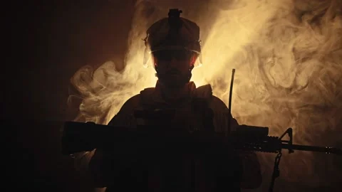 Silhouette of Special Forces Operator in full protection gear with assault rifle Stock Footage 158300979