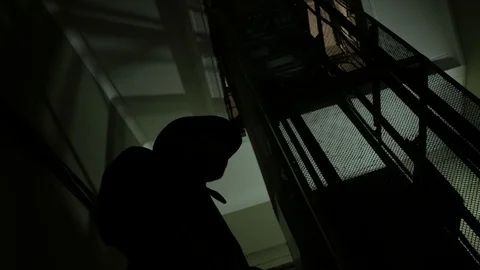 Silhouette of spy man with hat in the dark corridor  Stock Footage 116348528