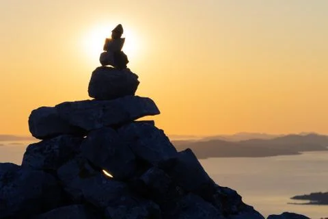 Silhouette of stack of rocks on top of the mountain overlooking the adriatic Stock Photos