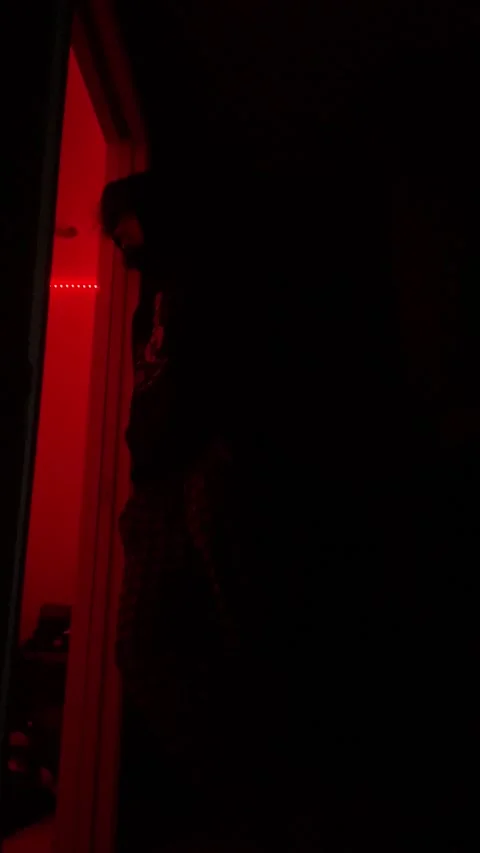 Silhouette standing in the dark with red background Stock Footage 168626191