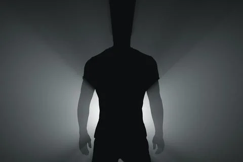 Silhouette of a standing man in the rays of light Stock Photos