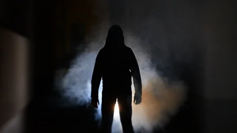 A silhouette of a stranger/killer standing in the allyway at night Stock Footage