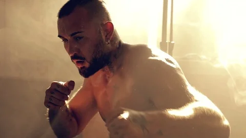Silhouette strong boxer training and moving punching in gym slow motion close Stock Footage 80963275