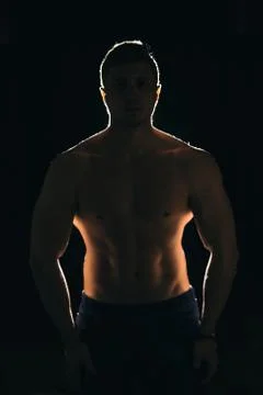 Silhouette of a strong man with dramatic light and dark background Stock Photos