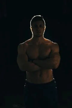 Silhouette of a strong man with dramatic light and dark background Stock Photos