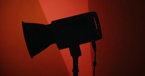 Silhouette of Studio Light Against Red Background Stock Photos