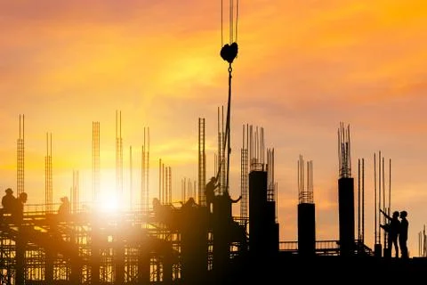 Silhouette sunset of Engineer and worker on building site, construction site Фото