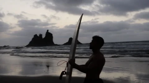 Silhouette of a surfer at the beach with surfboard, concept of love nature Stock Footage 202189739