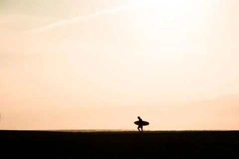 Silhouette of surfer Stock Photos