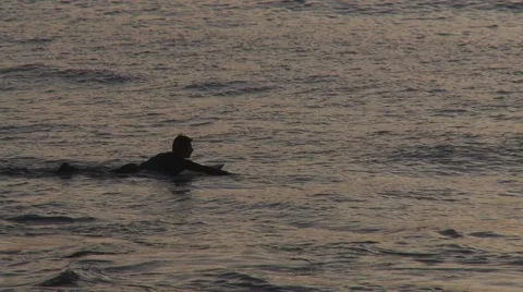 Silhouette of a surfer waiting for a wave Stock Footage 64220780