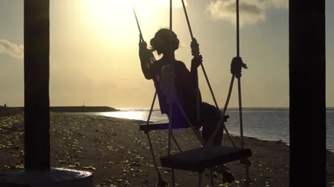 Silhouette on a Swing at Sunset Beach Stock Footage 277025980