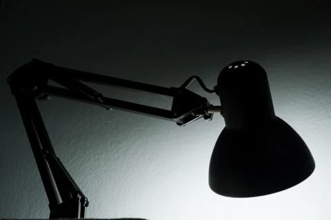 Silhouette of a table lamp on the background of a window in the morning at da Stock Photos